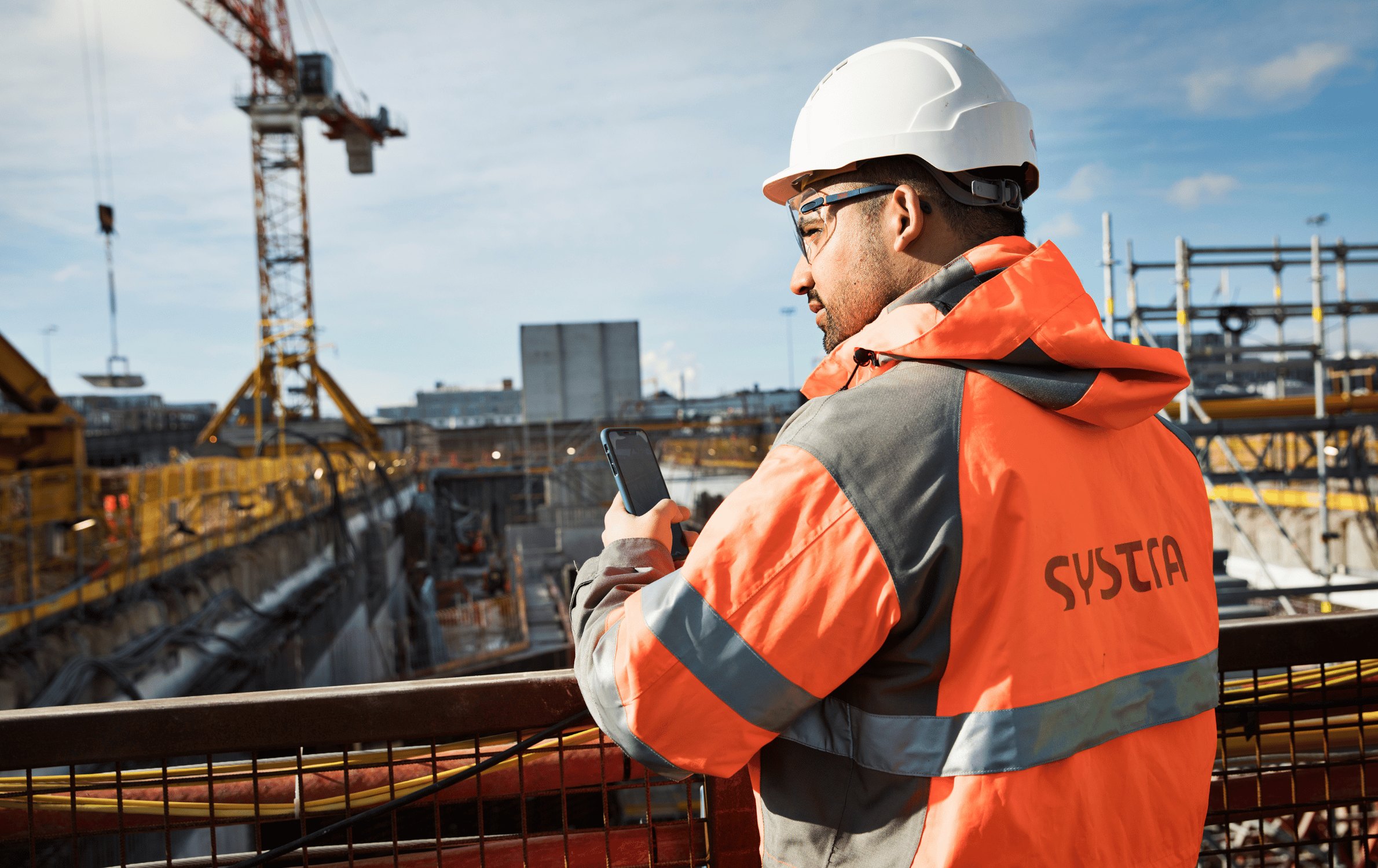 Engineer on a construction site coordinating rail-adjacent works