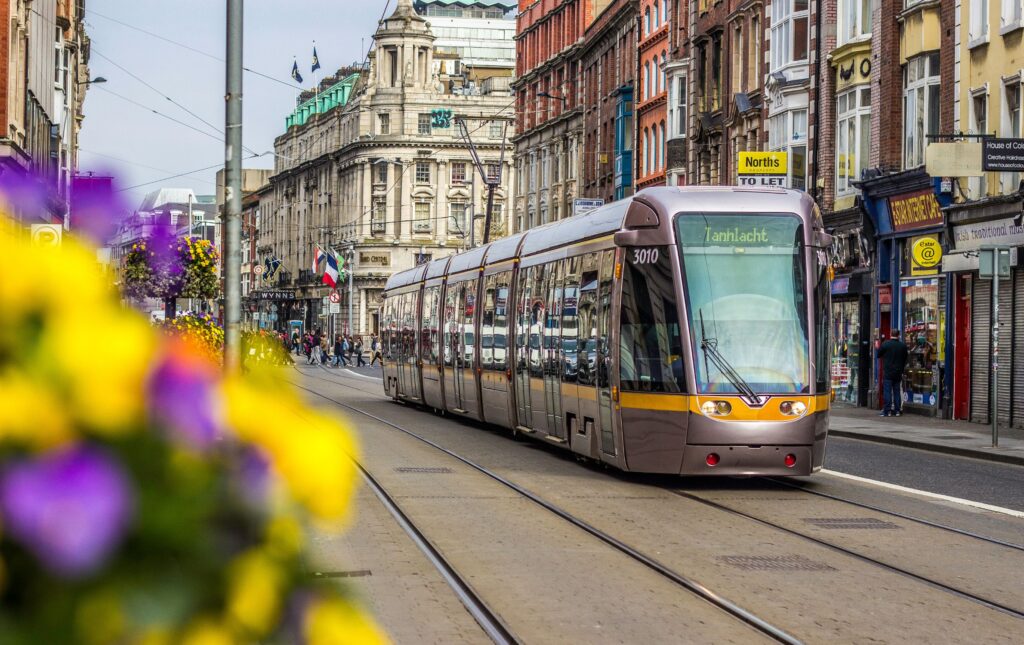 LUAS tram in Dublin street with flowers in the foreground