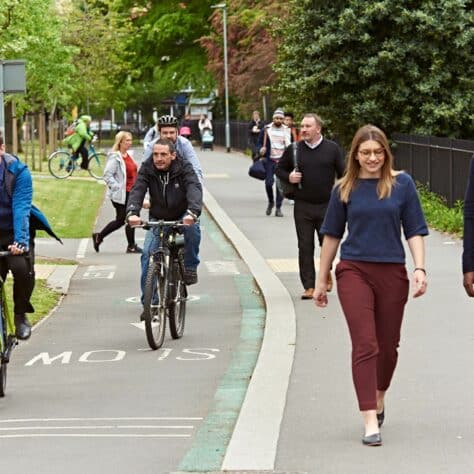 people walking and cycling on a path