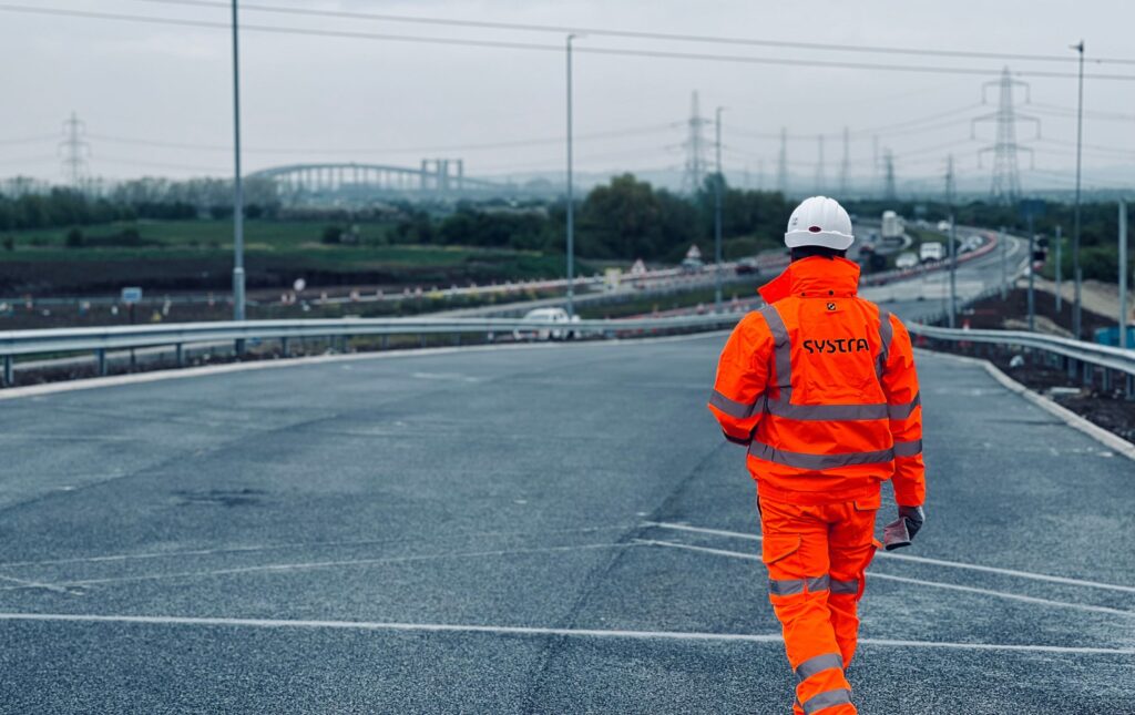 SYSTRA specialist in high vis walking along the road at Grovehurst Junction