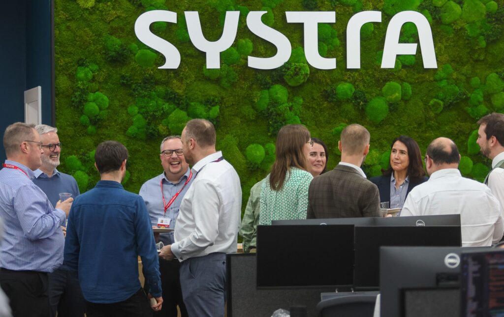 SYSTRA team talking and laughing in the SYSTRA Edinburgh office