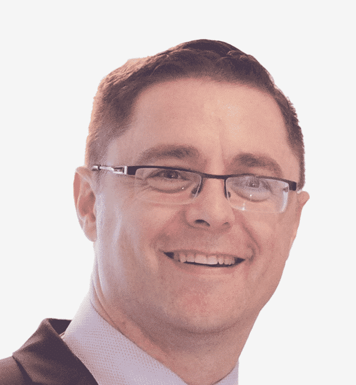 Headshot photo of Paul Gotts. He is smiling at the camera. The background is plain.