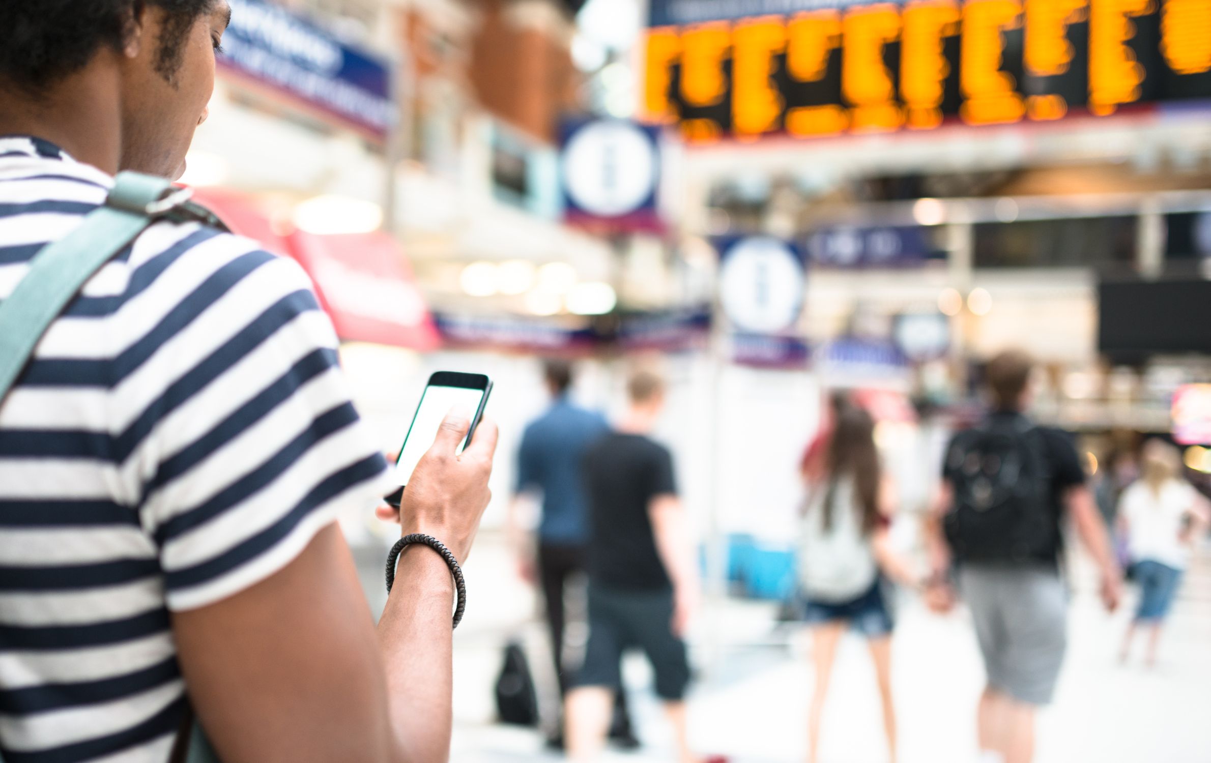 Person on mobile phone at in London Liverpool Street train station