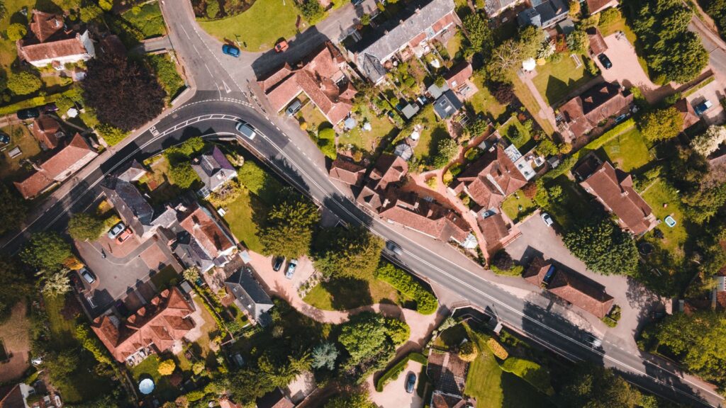 Aerial photography of a road through houses in a UK town.