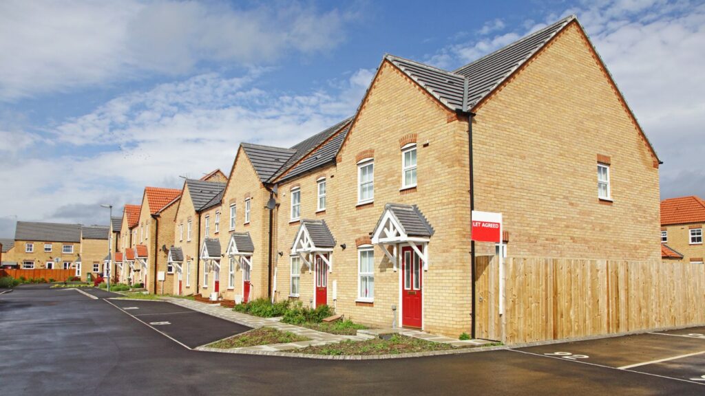 Row of new houses with road, pavement and car parking spaces